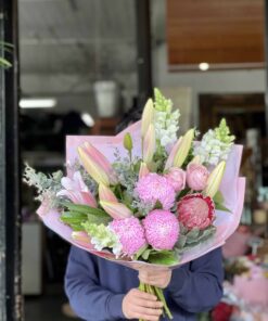 Man Holding A Bouquet of Brings A Smile Arrangement