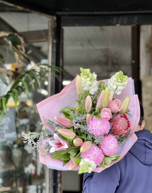Man Carrying The Bings A Smile Bouquet Over His Shoulder