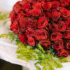 A bouquet of red roses with a ferns