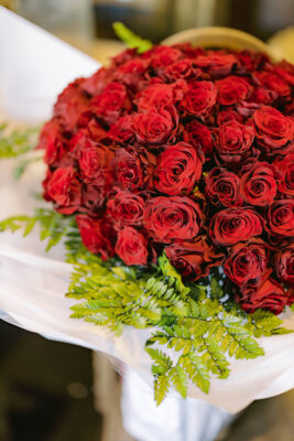 A bouquet of red roses with a ferns