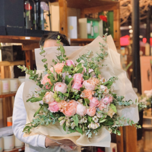 Woman holding a bouquet of pink roses