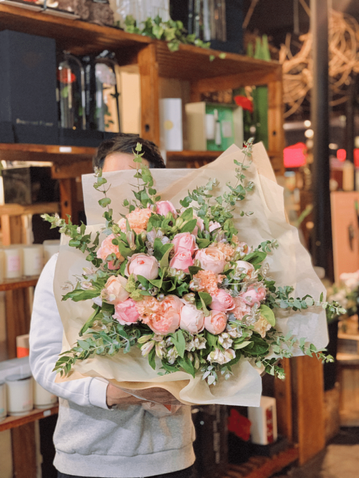 Woman holding a bouquet of pink roses