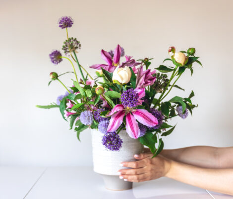 vase-with-fresh-summer-flowers-in-female-hands-on-2025-03-16-18-45-41-utc-470x400